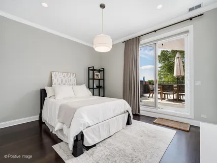 a bedroom with a large bed and a large window