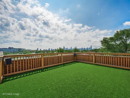 a view of a yard with wooden fence
