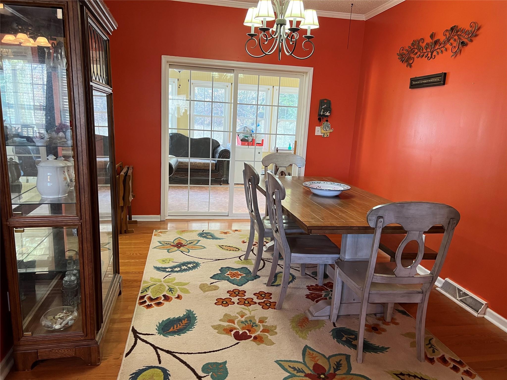 314 Windy Ridge Drive Rutherfordton, NC 28139 - Photo 11 of 46 a view of a dining room with furniture wooden floor and a chandelier
