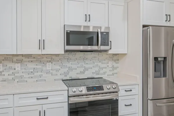 a kitchen with a sink stove and microwave