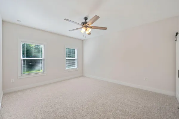 a view of a livingroom with a ceiling fan and entryway