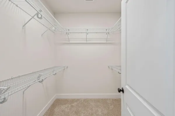 a view of a room with wooden floor and a bathroom