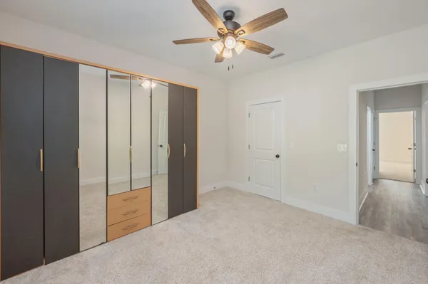 an empty room with a window and a fan