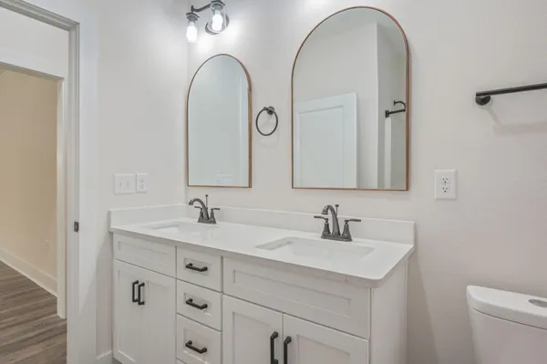 a bathroom with a double vanity sink and a mirror