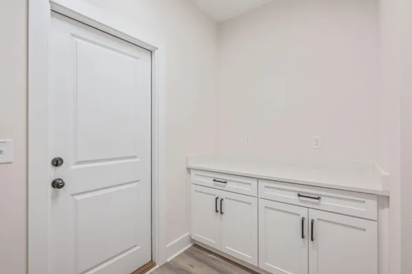 an empty room with a white walls and white walls