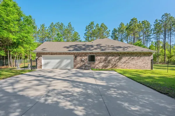 a view of a house with a yard and garage