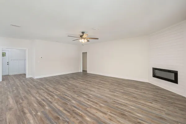 a view of an empty room and wooden floor