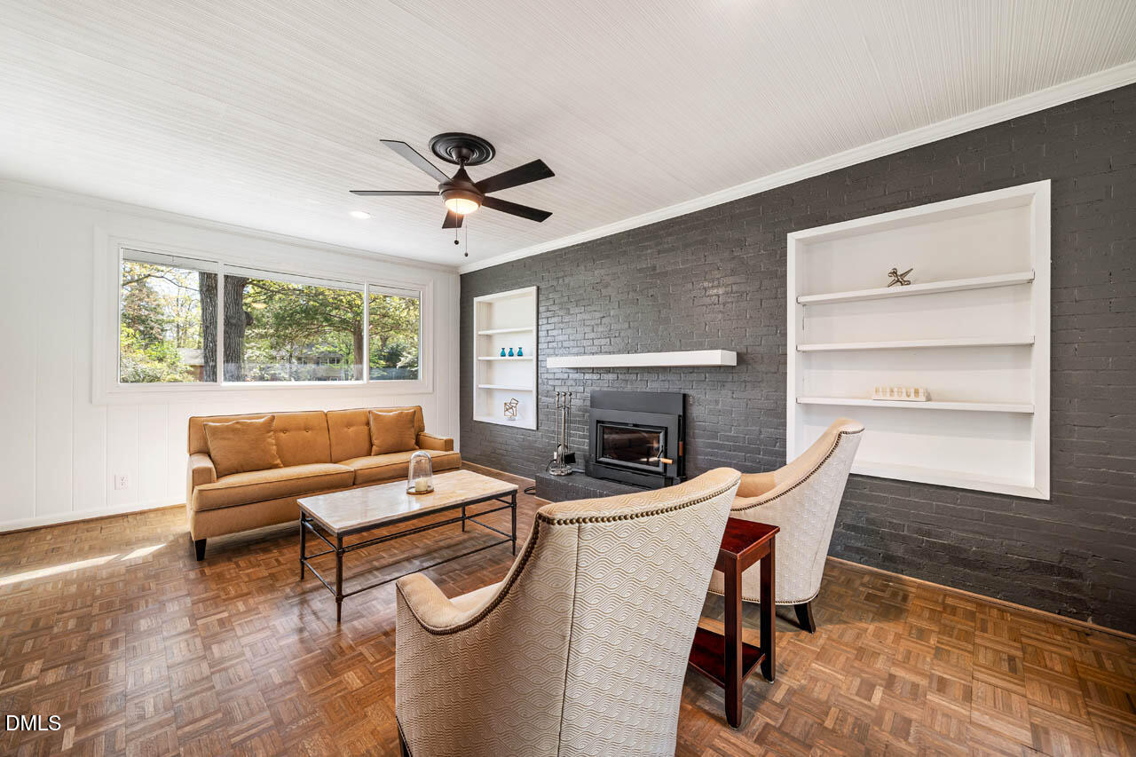231 Flemington Road Chapel Hill, NC 27517 - Photo 15 of 43 a living room with furniture a fireplace and a large window