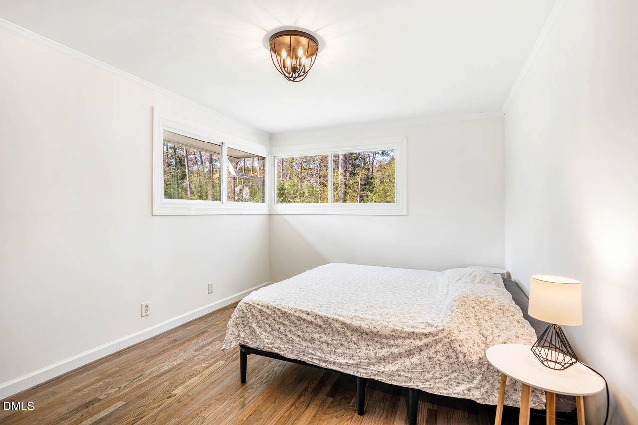 231 Flemington Road Chapel Hill, NC 27517 - Photo 18 of 43 a bedroom with a bed and painting on the wall
