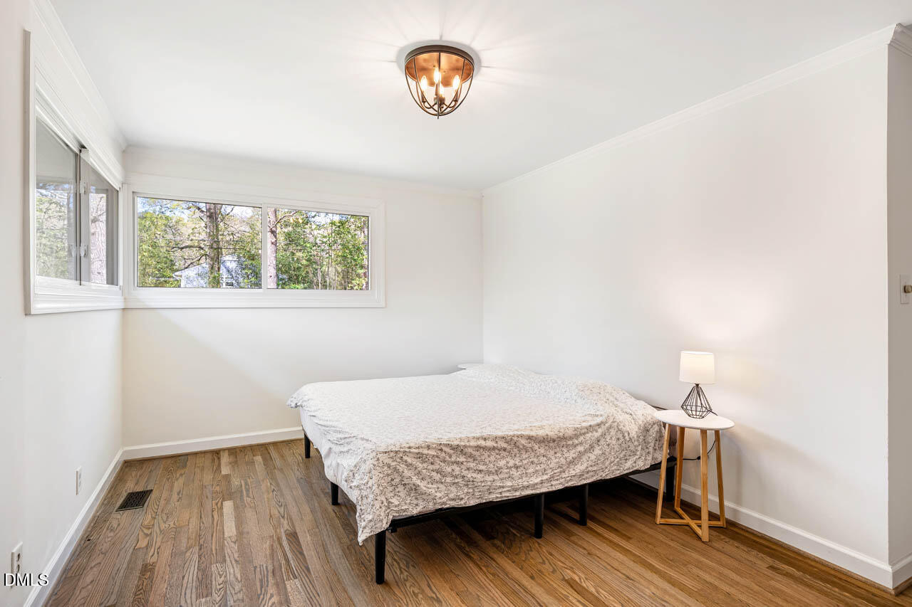 231 Flemington Road Chapel Hill, NC 27517 - Photo 19 of 43 a bedroom with a bed and a window