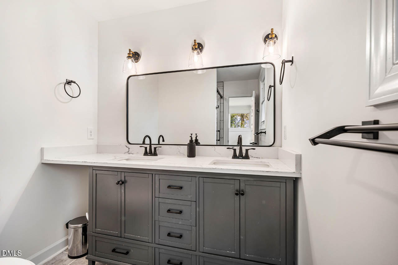 231 Flemington Road Chapel Hill, NC 27517 - Photo 21 of 43 a bathroom with a double vanity sink and a mirror