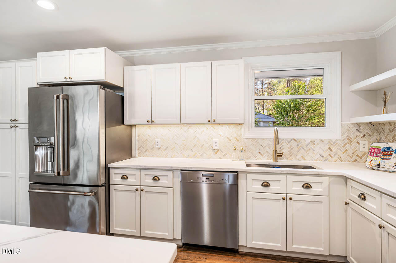 231 Flemington Road Chapel Hill, NC 27517 - Photo 5 of 43 a kitchen with a sink a refrigerator a washer and dryer