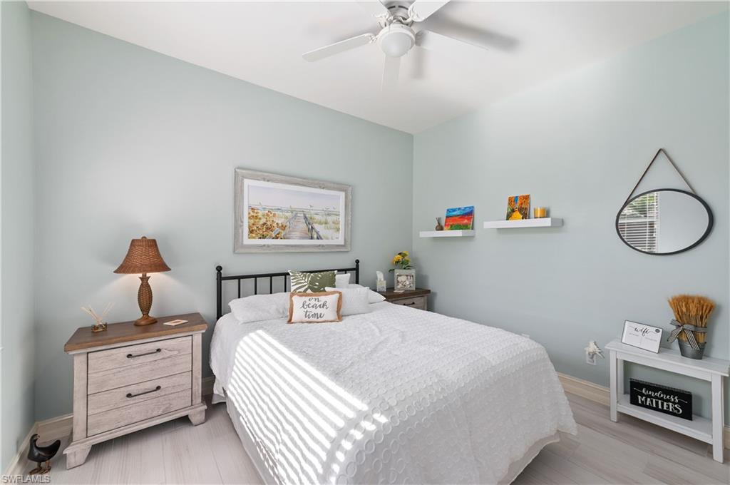 800 Carrick Bend Circle, Unit 103 Naples, FL 34110 - Photo 11 of 30 Bedroom with ceiling fan and light wood-style floors