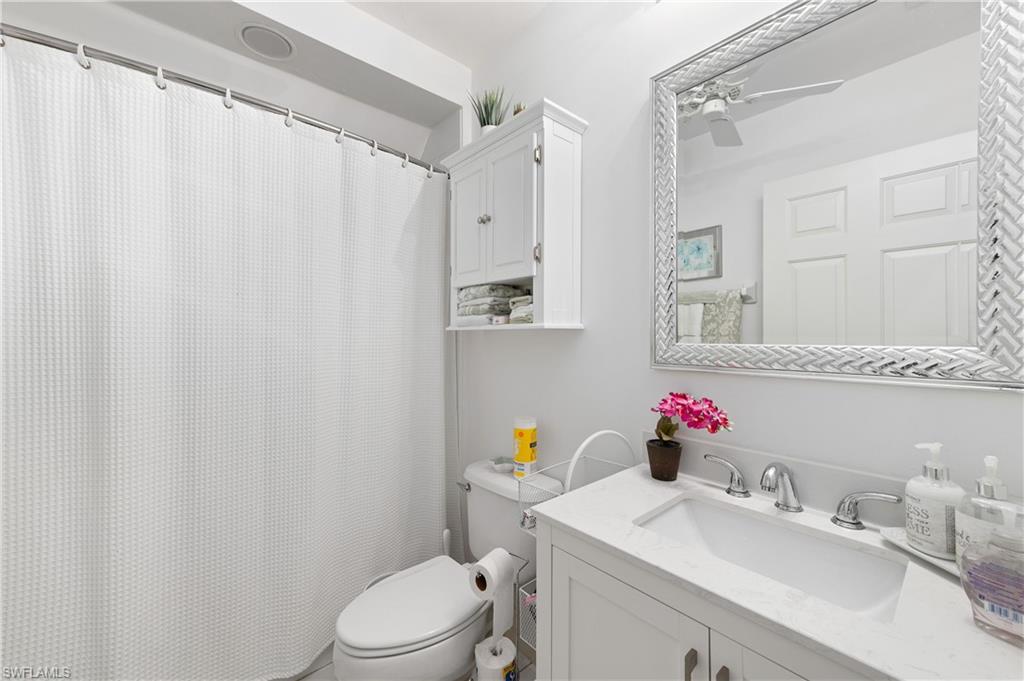 800 Carrick Bend Circle, Unit 103 Naples, FL 34110 - Photo 12 of 30 Full bathroom featuring vanity and toilet
