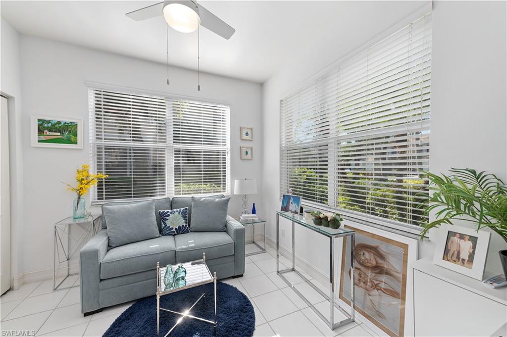 800 Carrick Bend Circle, Unit 103 Naples, FL 34110 - Photo 14 of 30 Tiled living room with ceiling fan