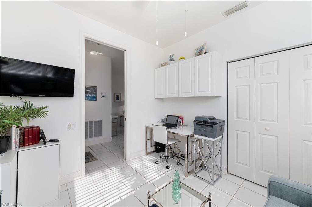 800 Carrick Bend Circle, Unit 103 Naples, FL 34110 - Photo 15 of 30 Home office with light tile patterned flooring and a ceiling fan