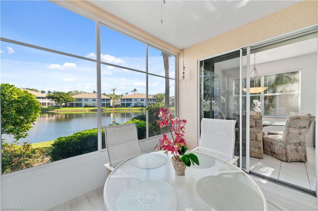 800 Carrick Bend Circle, Unit 103 Naples, FL 34110 - Photo 22 of 30 Sunroom / solarium featuring a textured wall, a water view, and tile patterned floors