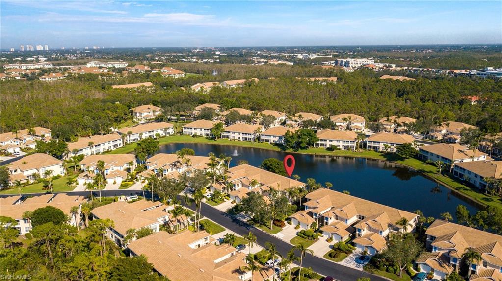 800 Carrick Bend Circle, Unit 103 Naples, FL 34110 - Photo 30 of 30 Aerial overview of property's location featuring a large body of water and a tree filled landscape