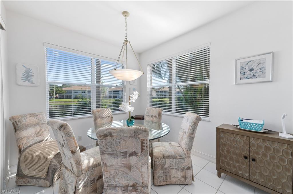 800 Carrick Bend Circle, Unit 103 Naples, FL 34110 - Photo 8 of 30 Dining area with tile patterned floors and baseboards