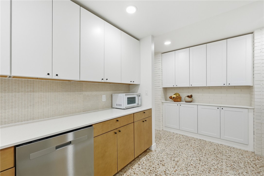 5513 March Street Robstown, TX 78380 - Photo 13 of 26 a kitchen with granite countertop white cabinets and white appliances