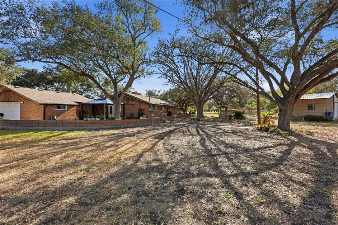 5513 March Street Robstown, TX 78380 - Photo 3 of 26 a front view of a house with a yard covered in snow