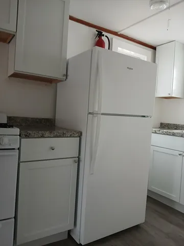 a white refrigerator freezer sitting in a kitchen