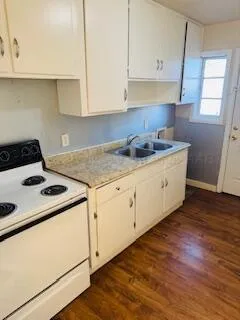 a view of walk in closet with wooden floor