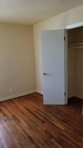 a view of a room with wooden floor