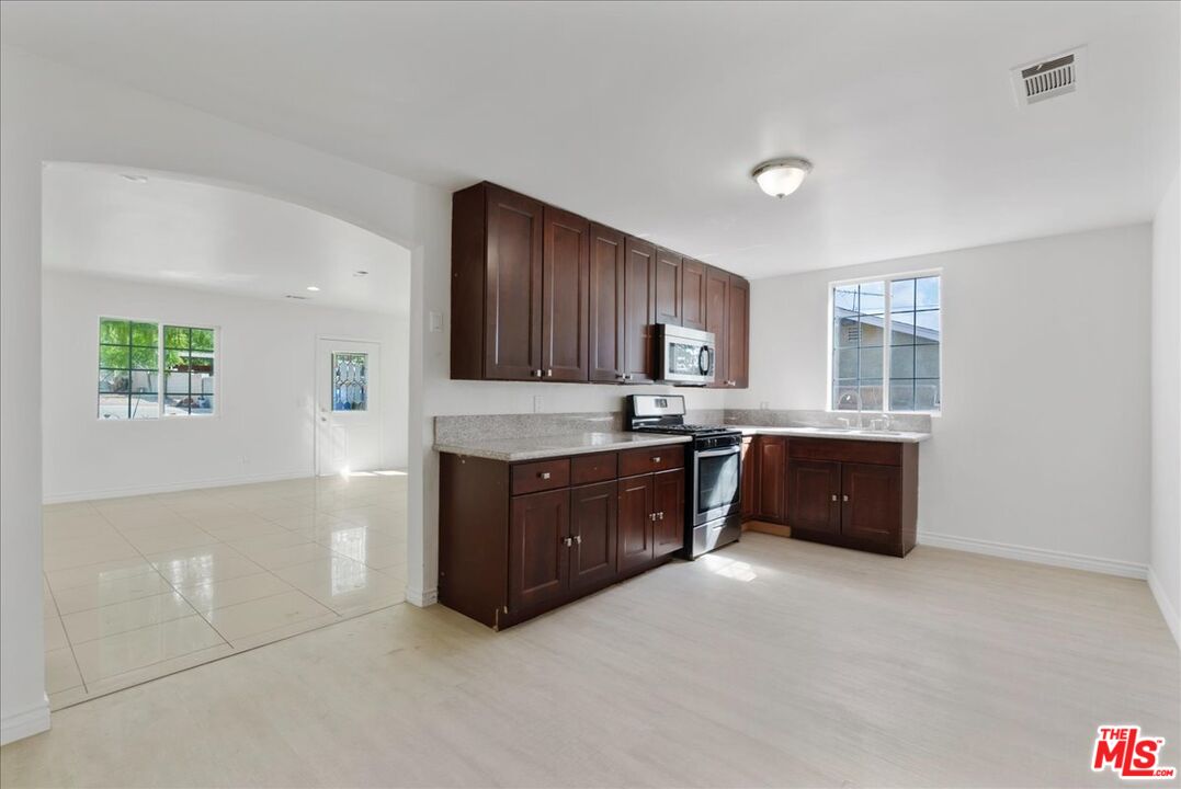 5854 Pedley Road Riverside, CA 92509 - Photo 18 of 36 a room with granite countertop a refrigerator and cabinets