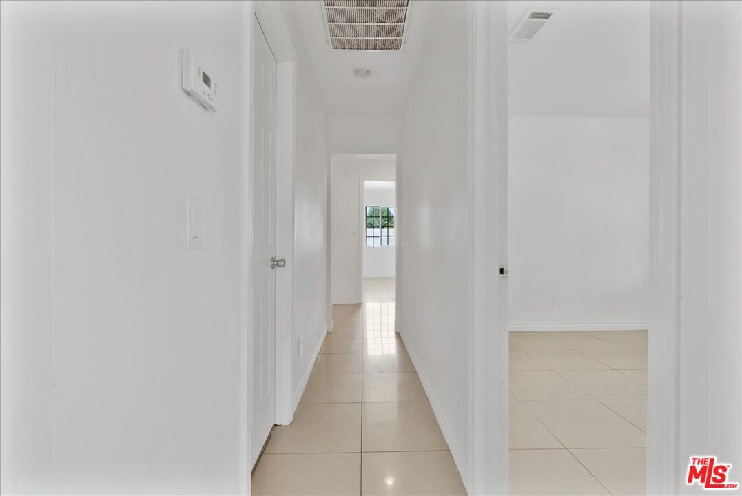 5854 Pedley Road Riverside, CA 92509 - Photo 21 of 36 a view of a hallway with wooden floor