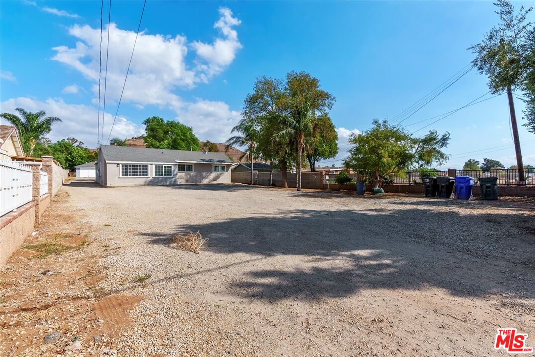 5854 Pedley Road Riverside, CA 92509 - Photo 32 of 36 a view of white house with a yard