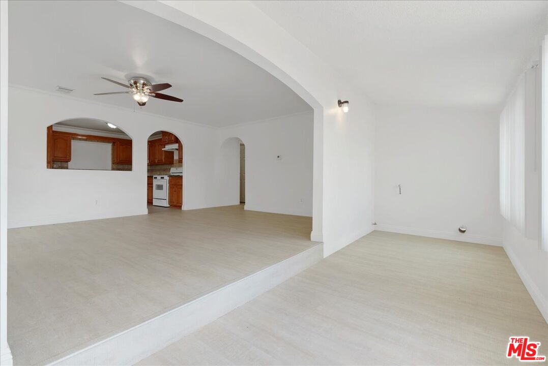 5854 Pedley Road Riverside, CA 92509 - Photo 5 of 36 an empty room with windows and fan