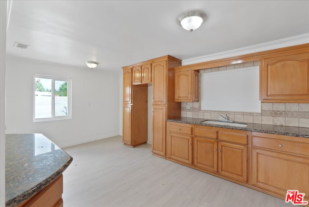 5854 Pedley Road Riverside, CA 92509 - Photo 10 of 36 a bathroom with a granite countertop sink and a mirror