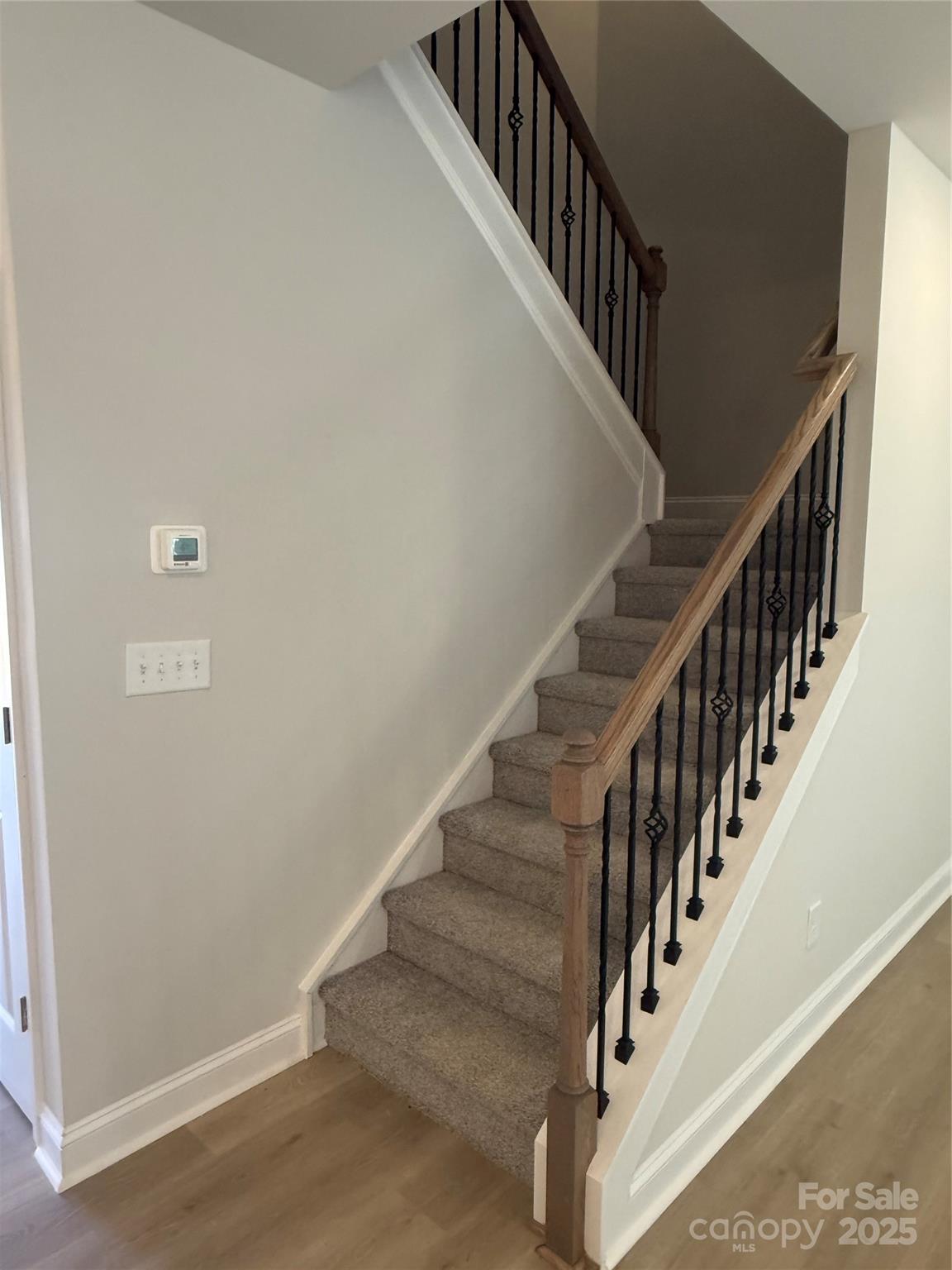 1258 Willow Grove Lane, Unit 101 Clover, SC 29710 - Photo 17 of 39 a view of staircase with wooden floor and white walls