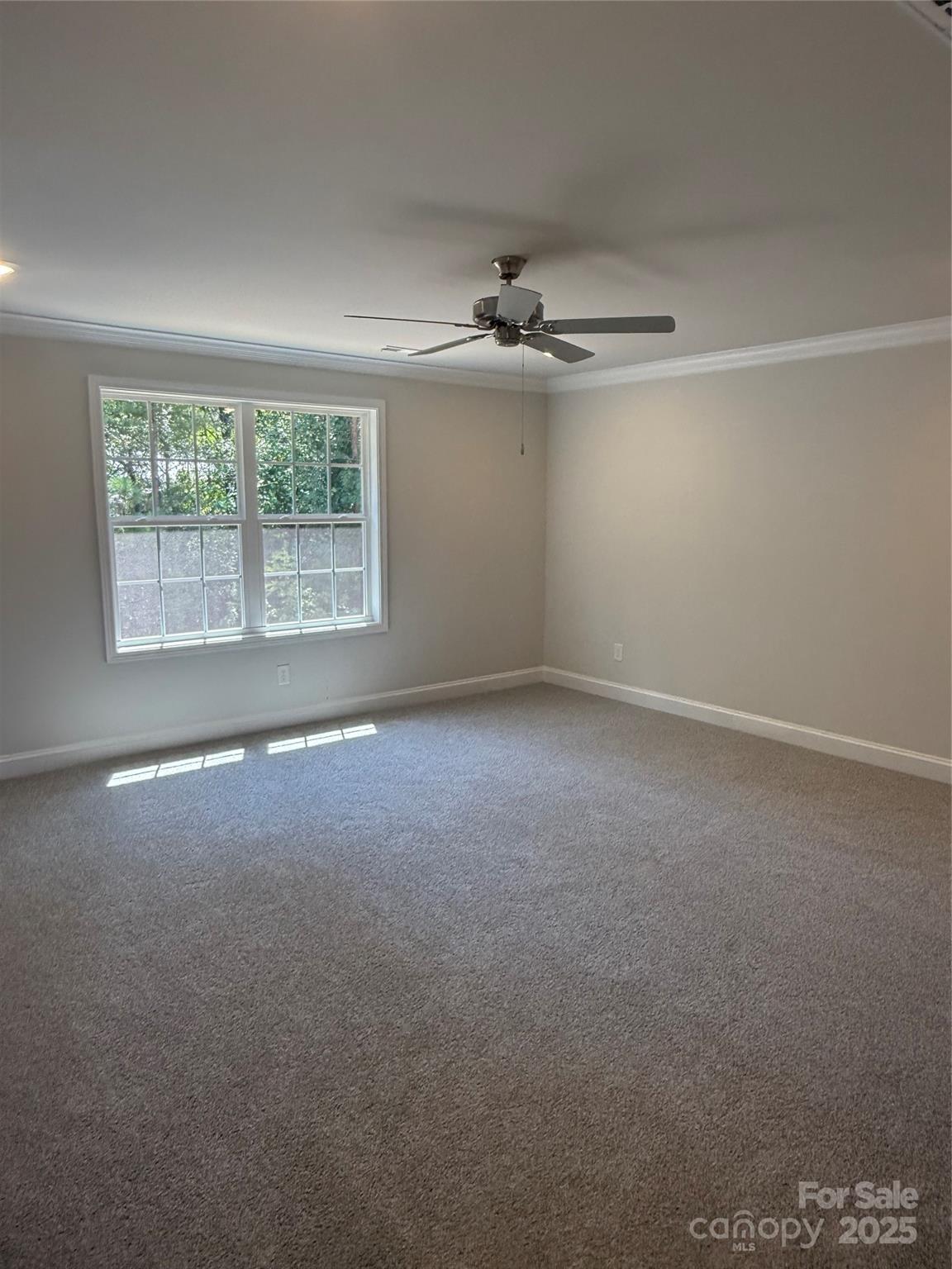 1258 Willow Grove Lane, Unit 101 Clover, SC 29710 - Photo 29 of 39 an empty room with a ceiling fan and windows