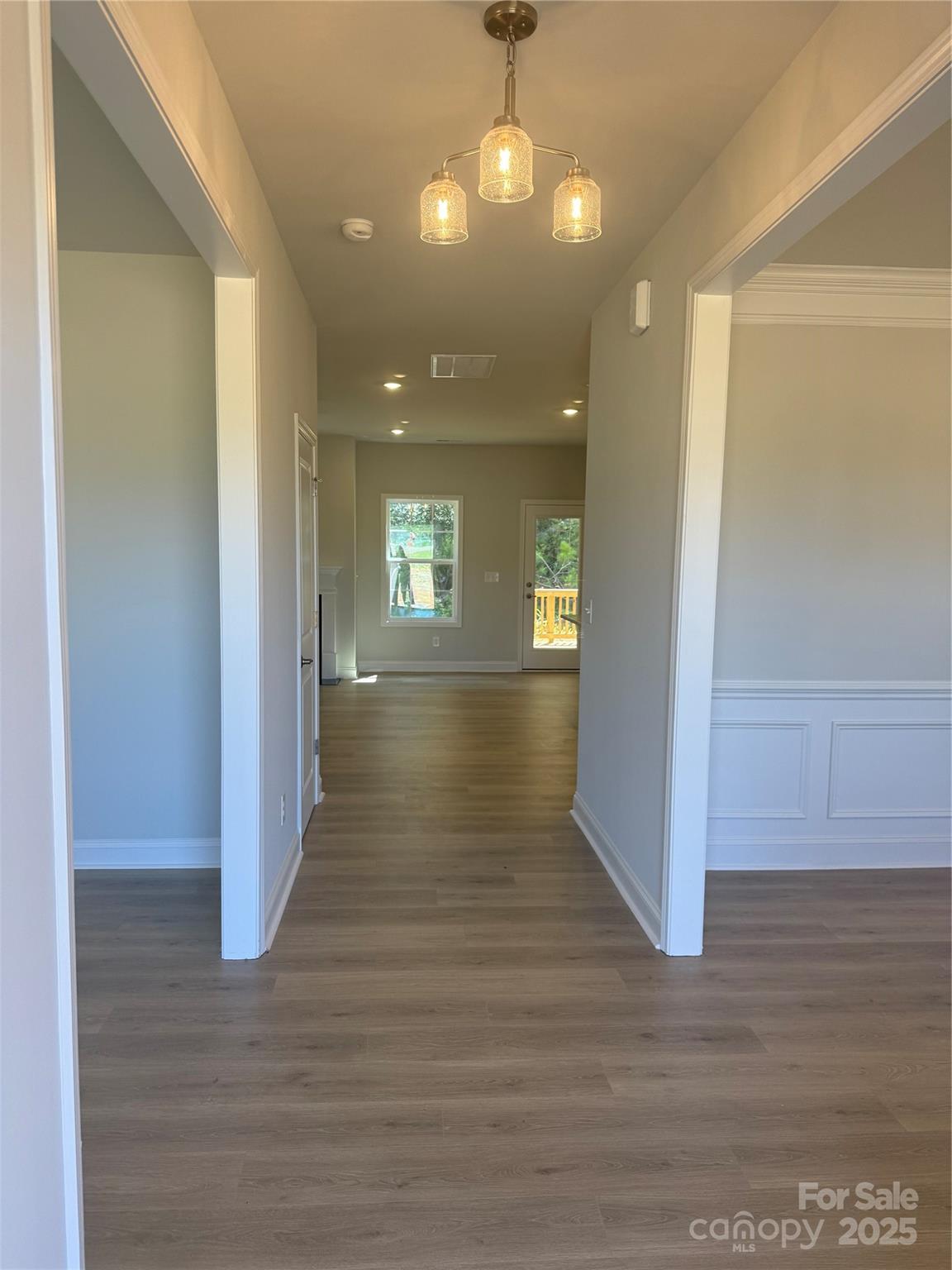 1258 Willow Grove Lane, Unit 101 Clover, SC 29710 - Photo 3 of 39 a view of wooden floor and chandelier in hallway