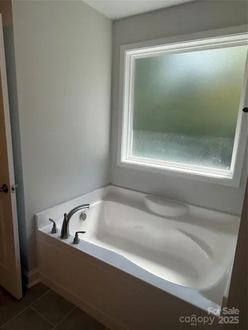 a bathroom with shower and bathtub
