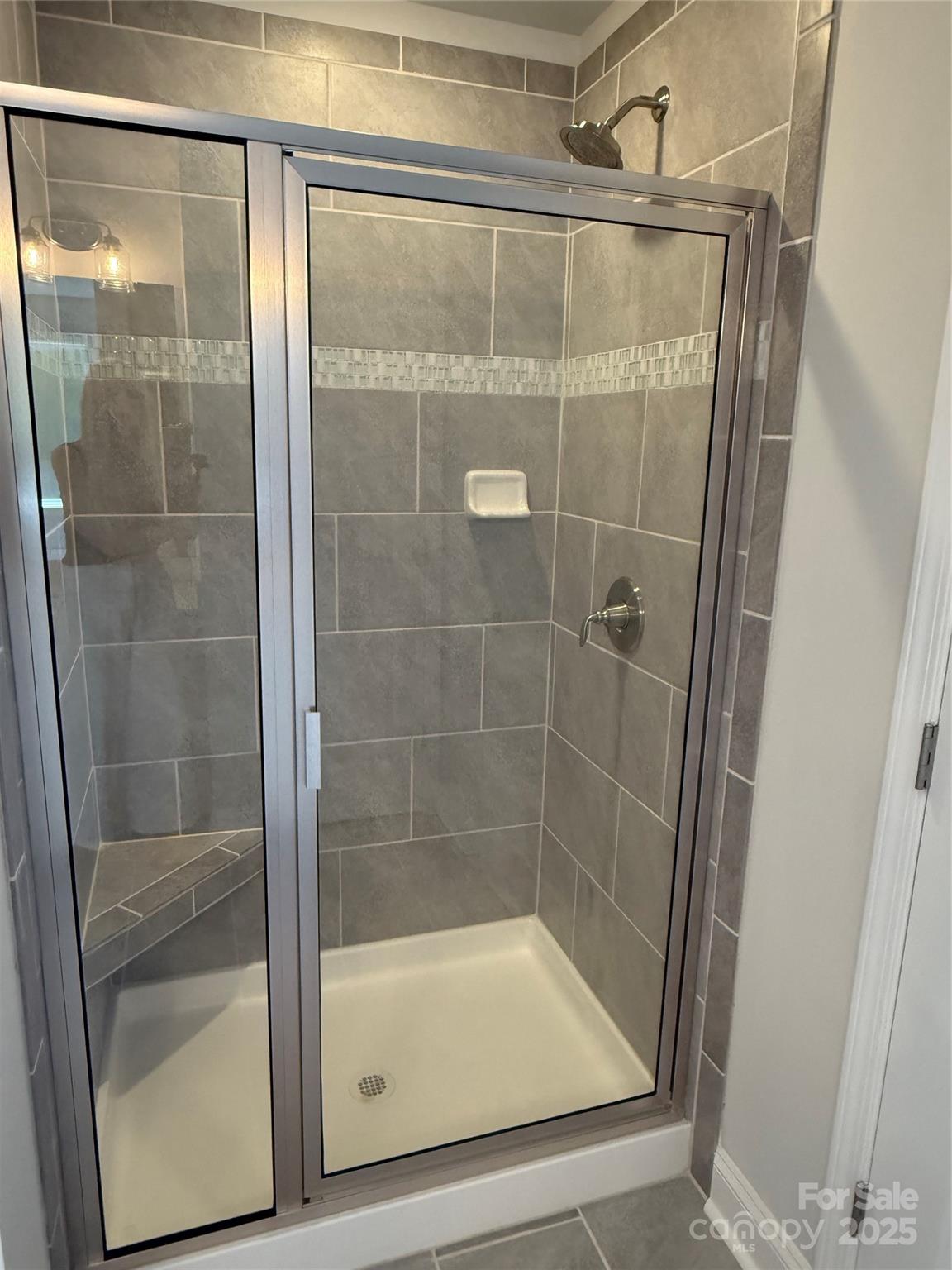 1258 Willow Grove Lane, Unit 101 Clover, SC 29710 - Photo 32 of 39 a bathroom with a glass shower door