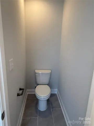 a white toilet sitting in a bathroom
