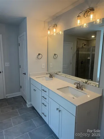 a bathroom with a double vanity sink and a mirror