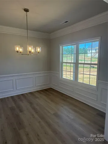 a view of a room with window and chandelier fan