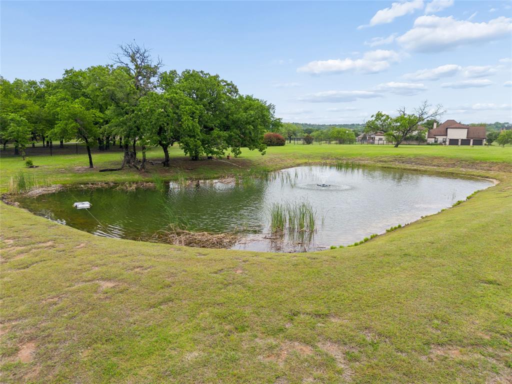 259 King Ranch Court Fort Worth, TX 76108 - Photo 36 of 38 a view of a lake with a big yard