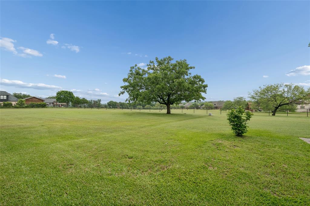 259 King Ranch Court Fort Worth, TX 76108 - Photo 38 of 38 a view of outdoor space with green field and trees
