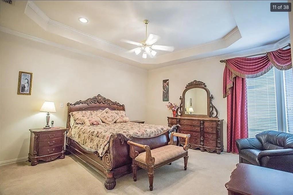 6512 Mesa Ridge Court Fort Worth, TX 76137 - Photo 13 of 24 a bedroom with a bed and a chandelier