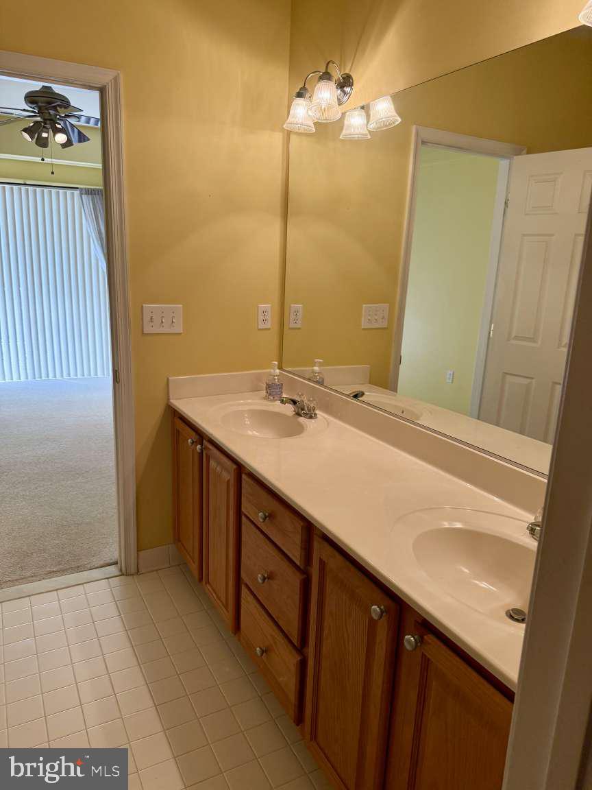 629 Ruxton Road, Unit 74 Solomons, MD 20629 - Photo 13 of 24 a bathroom with a sink and a mirror