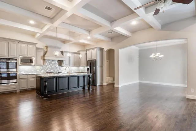 a large white kitchen with a large window