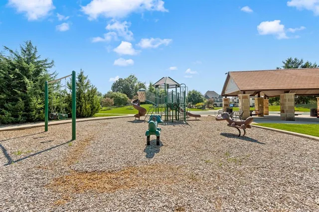 an aerial view of residential houses with outdoor space and swimming pool