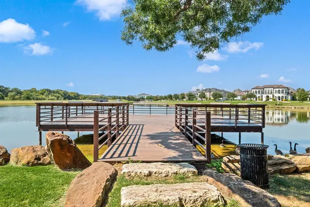 an aerial view of a swimming pool with a yard