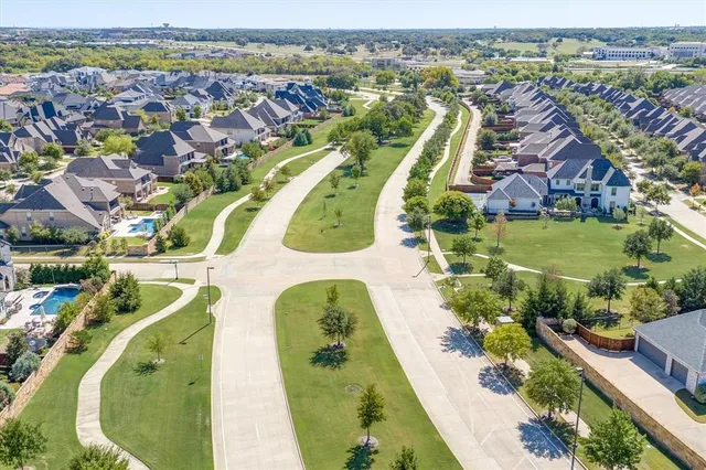 a patio with a table and chairs and a barbeque