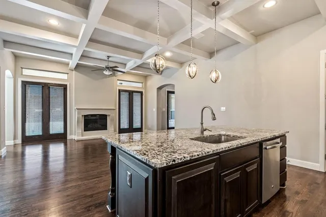a kitchen with a sink and a fireplace